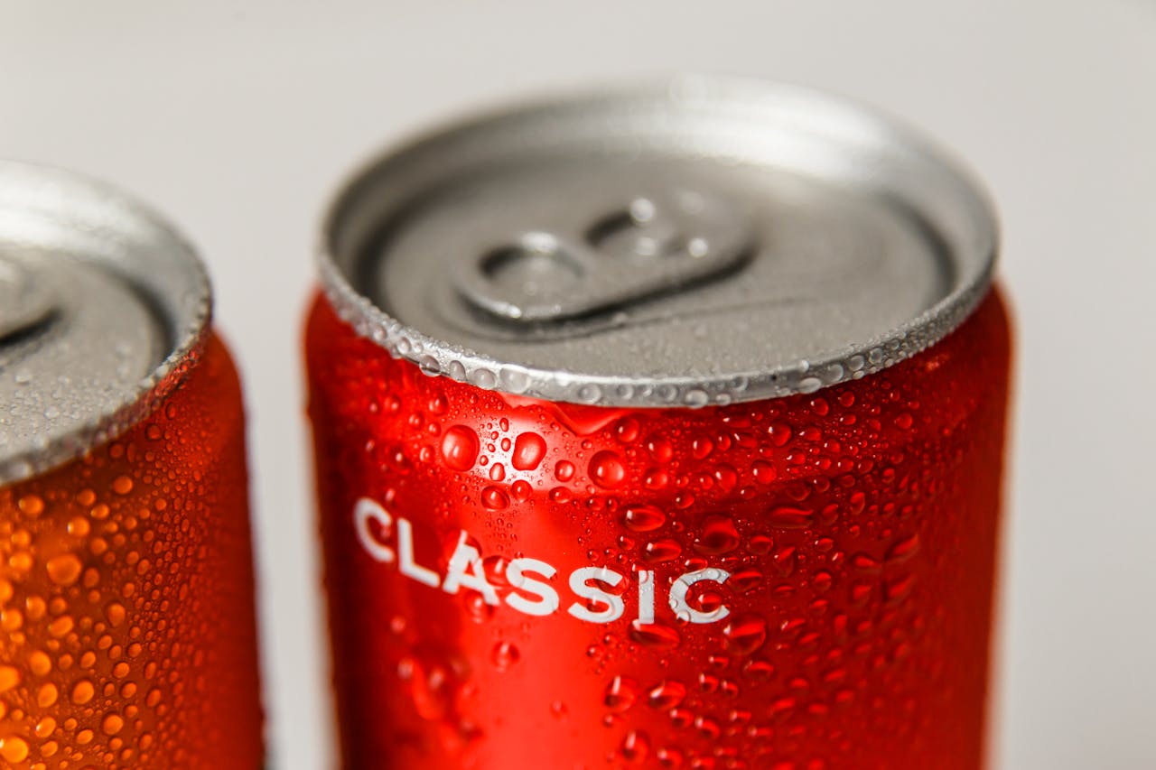 Crafting Captivating Headlines: Your awesome post title goes here Refreshing close-up of wet red and orange soda cans with condensation droplets.